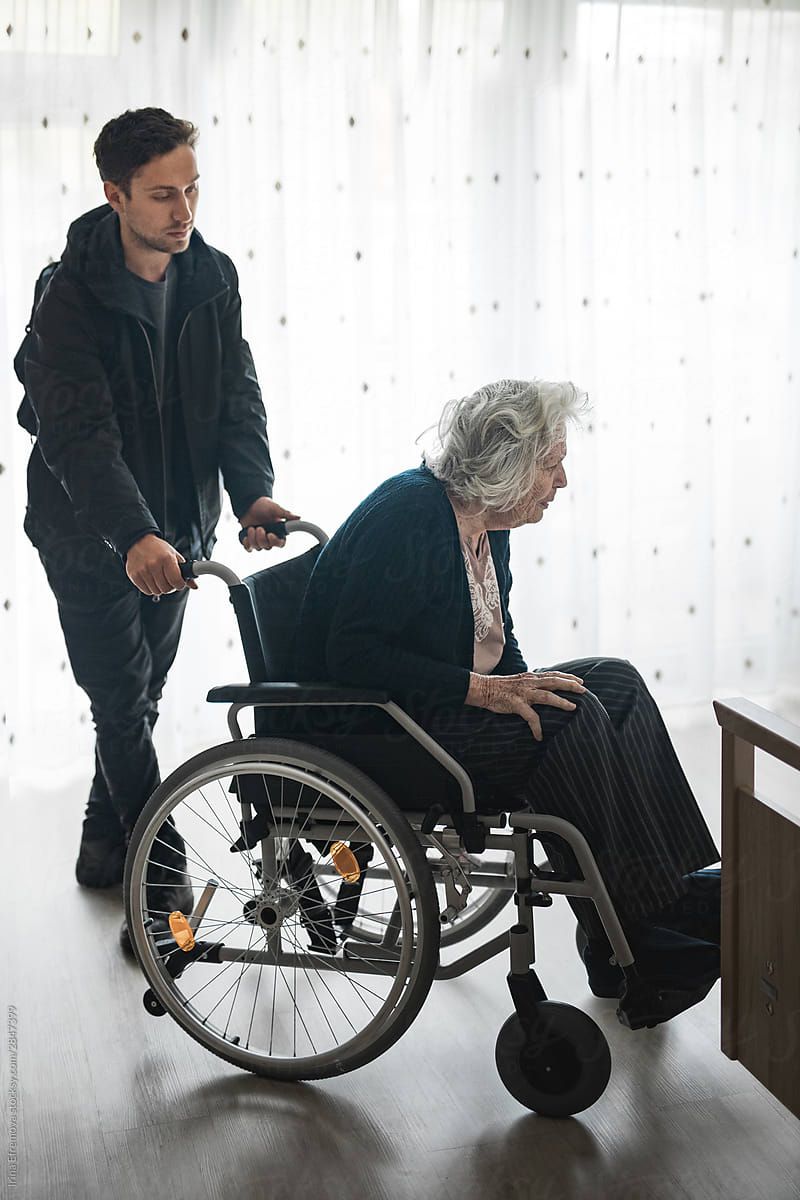 Grandson pushing his grandmother in a wheelchair