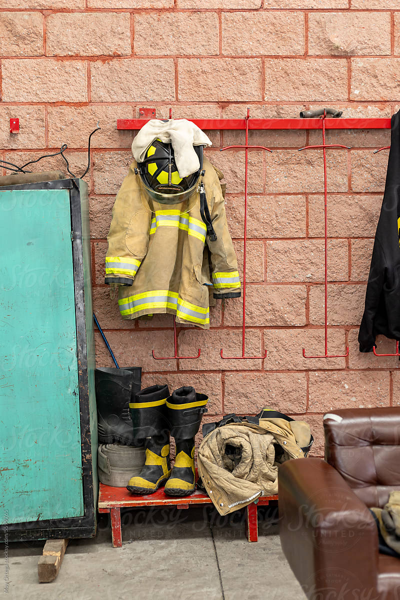 A Firefighter\'s Uniform Hanging On A Hook In The Locker Area