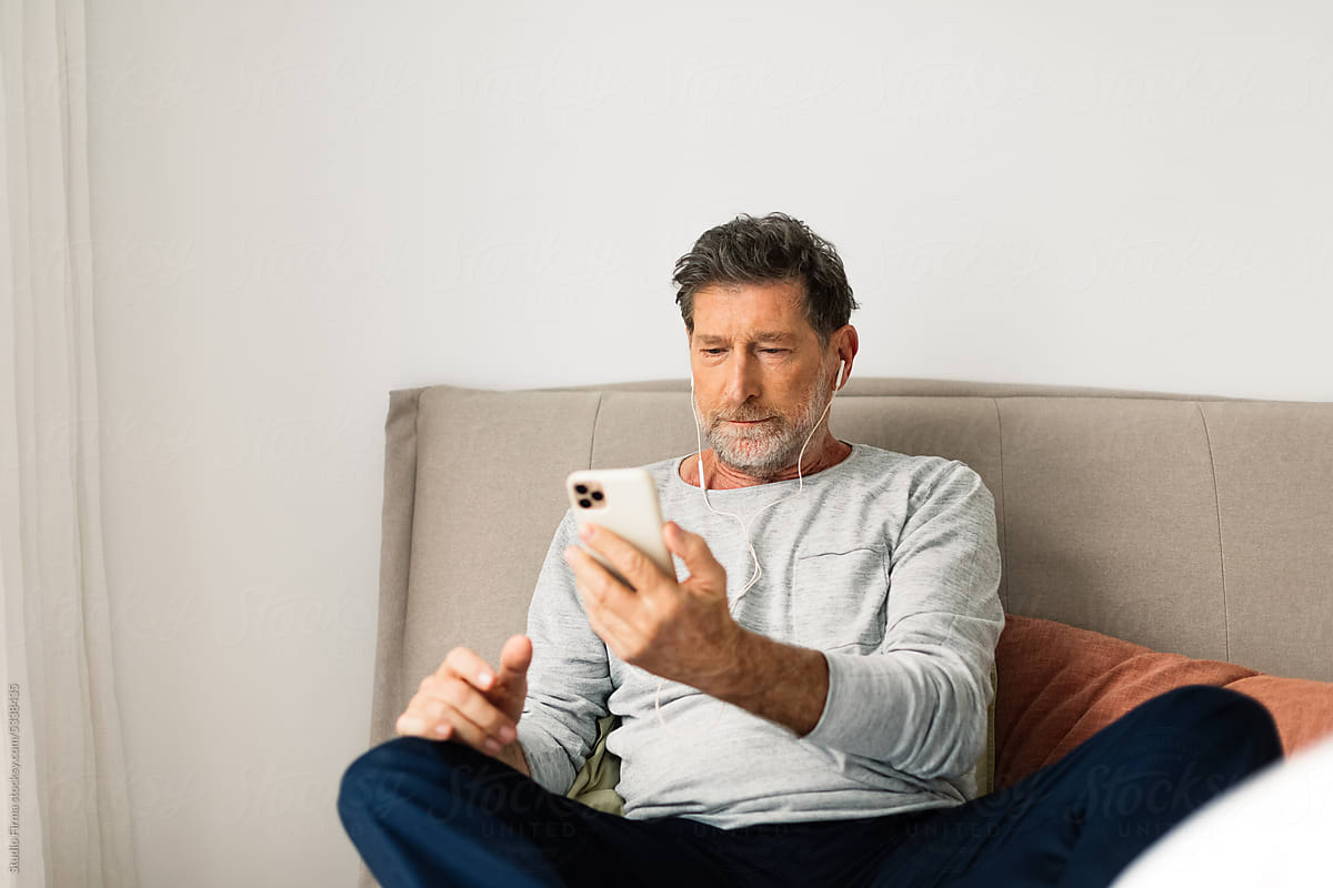 Senior Man Using Phone at Home