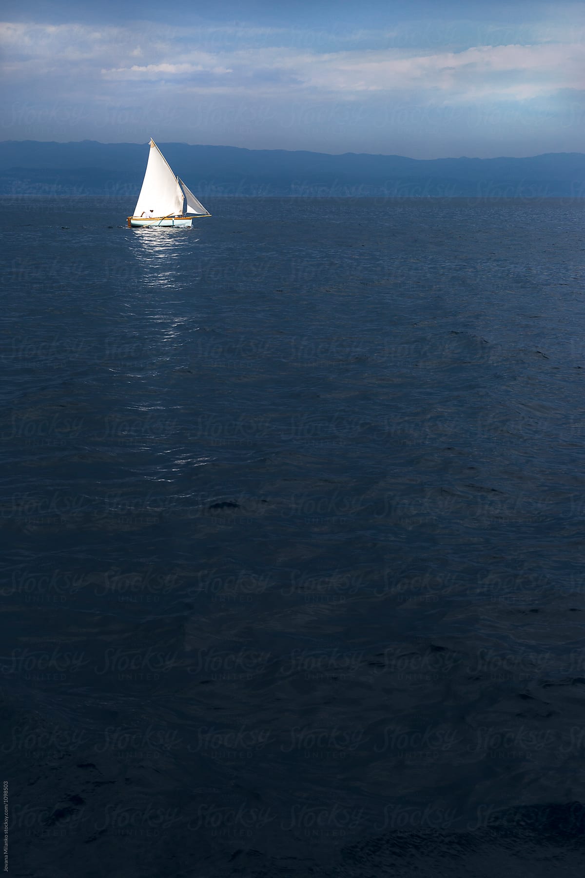 Traditional wooden sailboat  sailing the dark blue sea