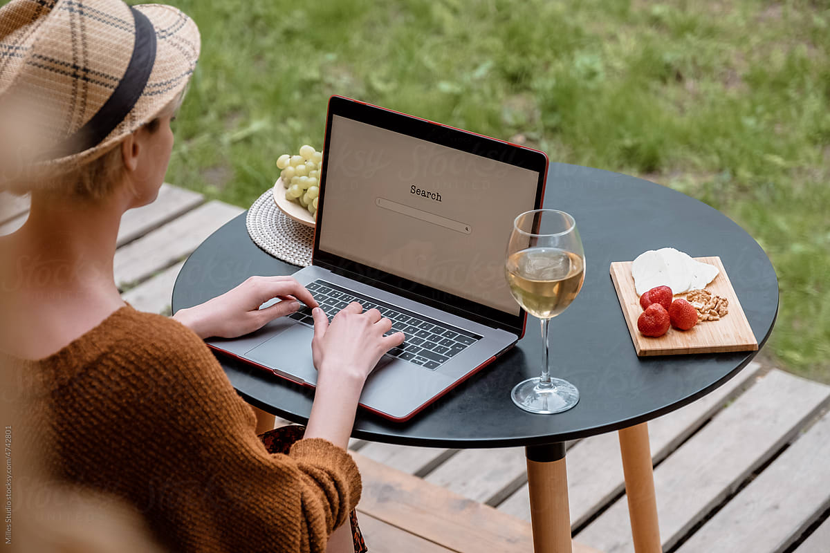 Woman using laptop on terrace