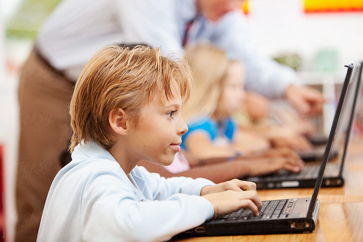Classroom: Boy Concentrates on Finishing Computer Work