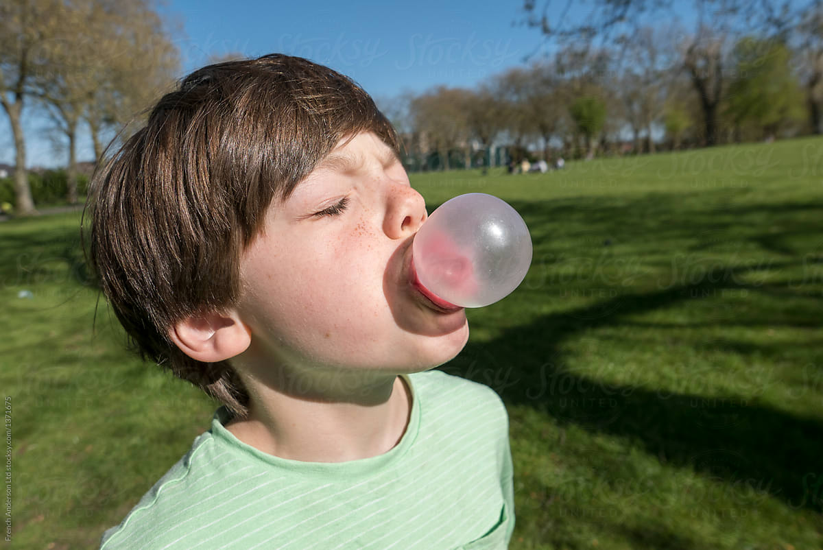 Boy blowing a bubble with bubble gum