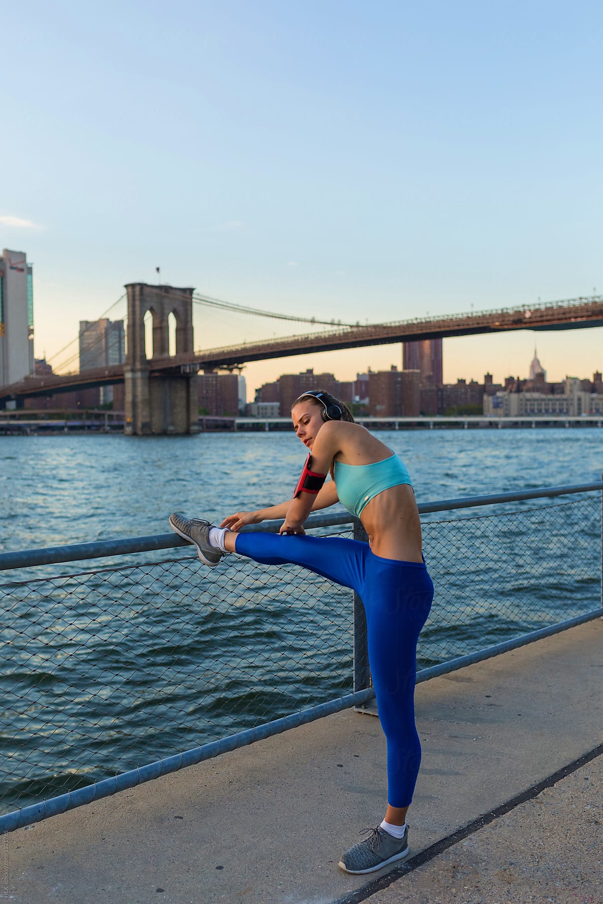 Young Beautiful Woman Doing Stretching in New York City. Manhattan Skyline
