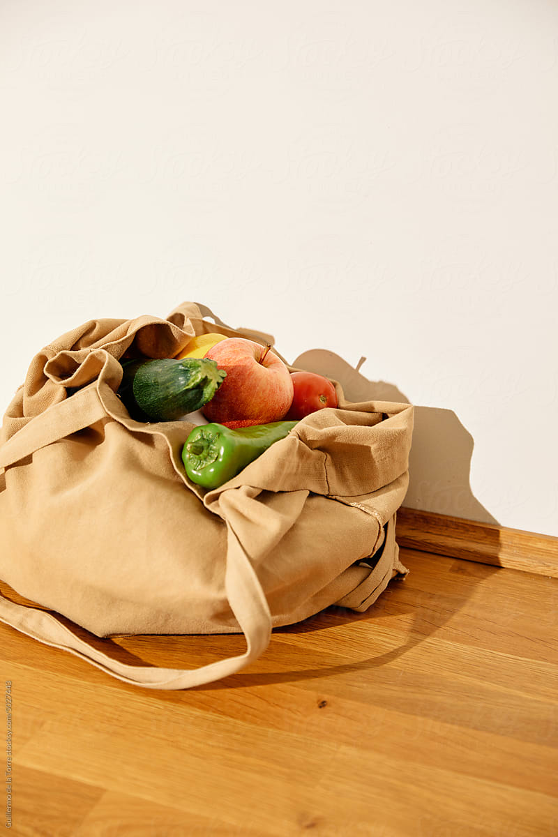 Fresh Fruits And Vegetables In Reusable Bags On Kitchen