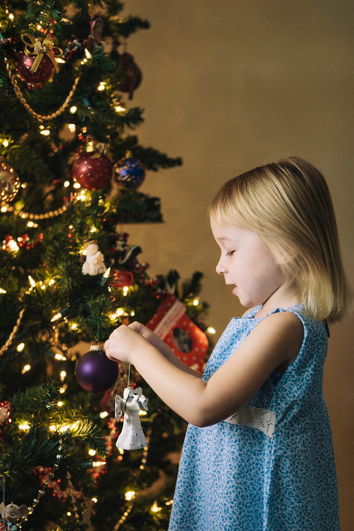 Little Girl Decorating Christmas Tree