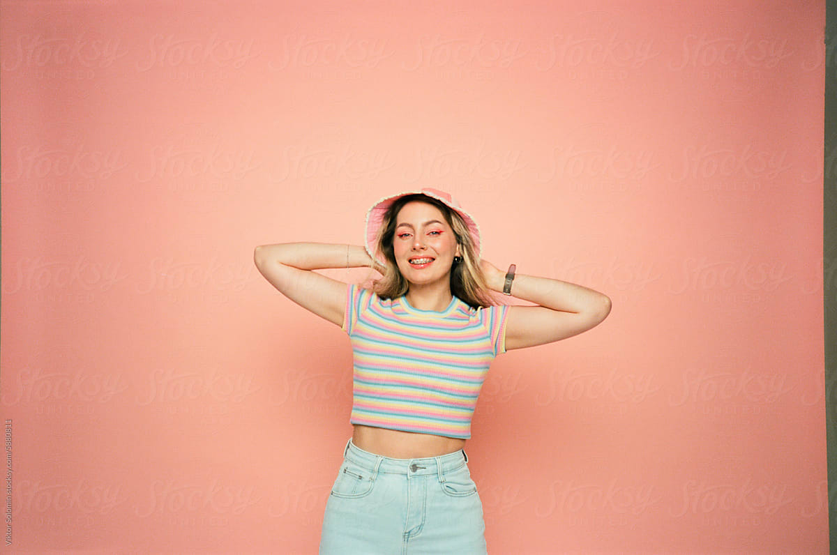 Smiling woman in casual outfit on peachy background