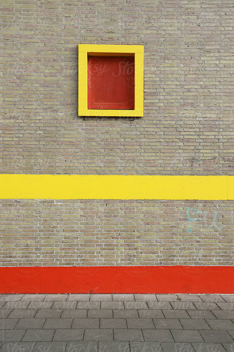 brick wall with red and yellow stripe