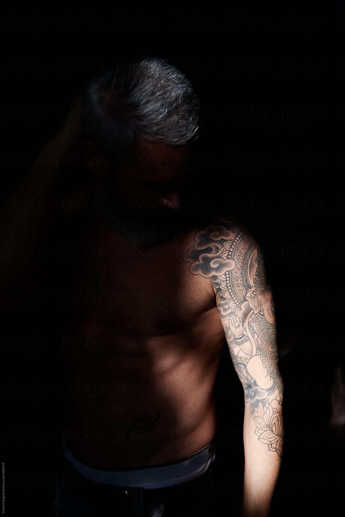 Anonymous tattooed male with naked torso