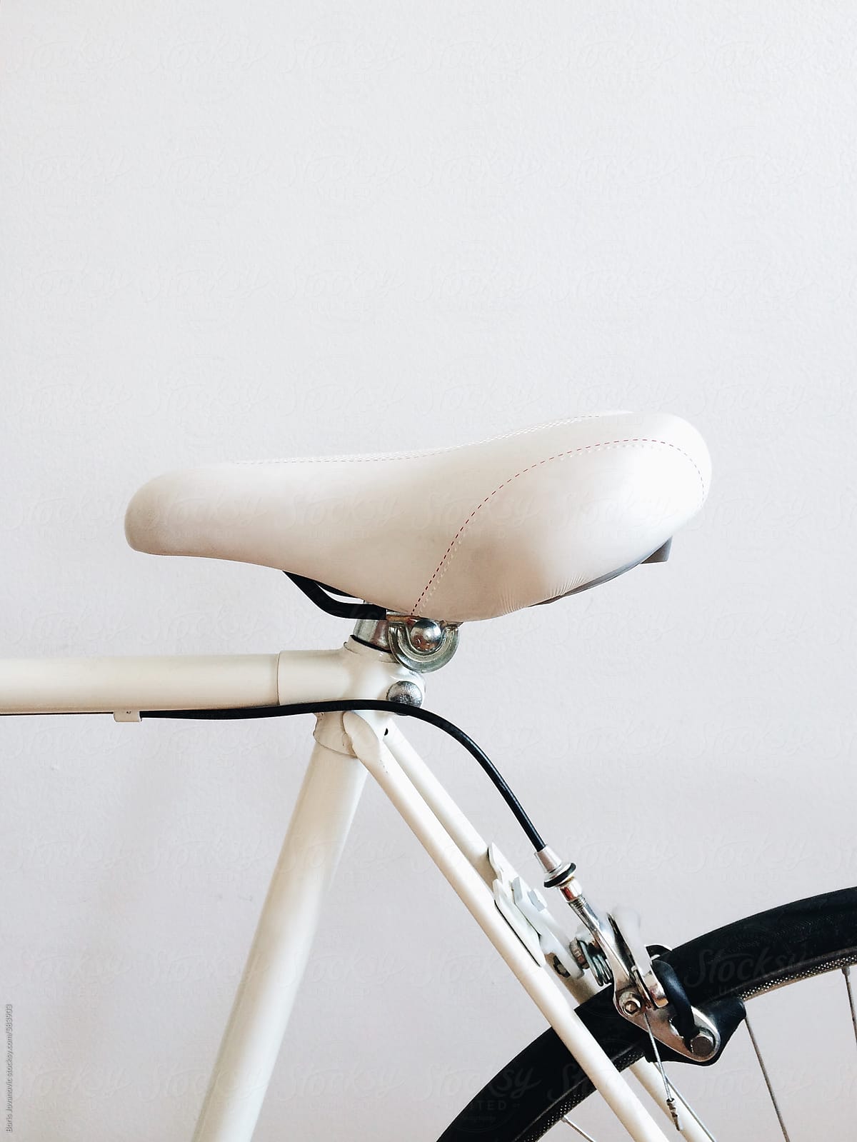 White bicycle on white wall