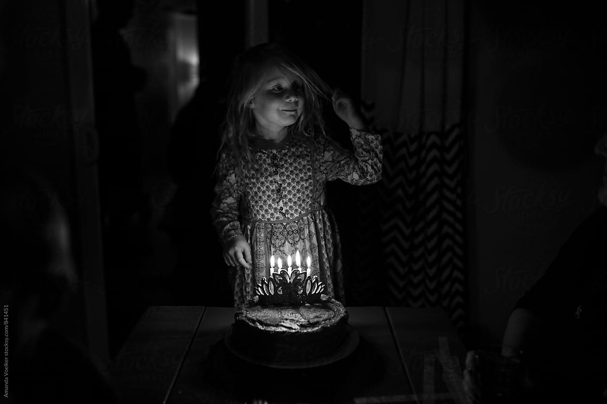 Little Girl Waiting to Blow out Birthday Candles