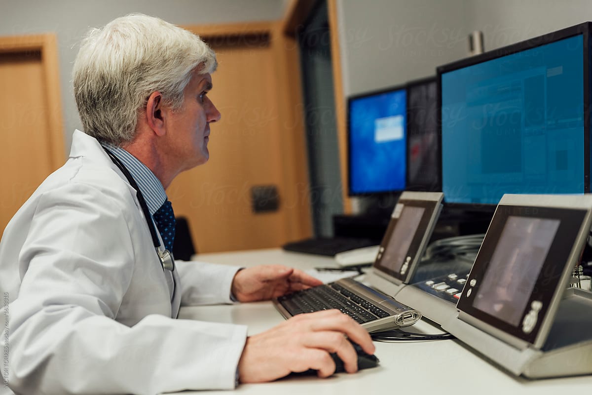 Adult doctor using computer