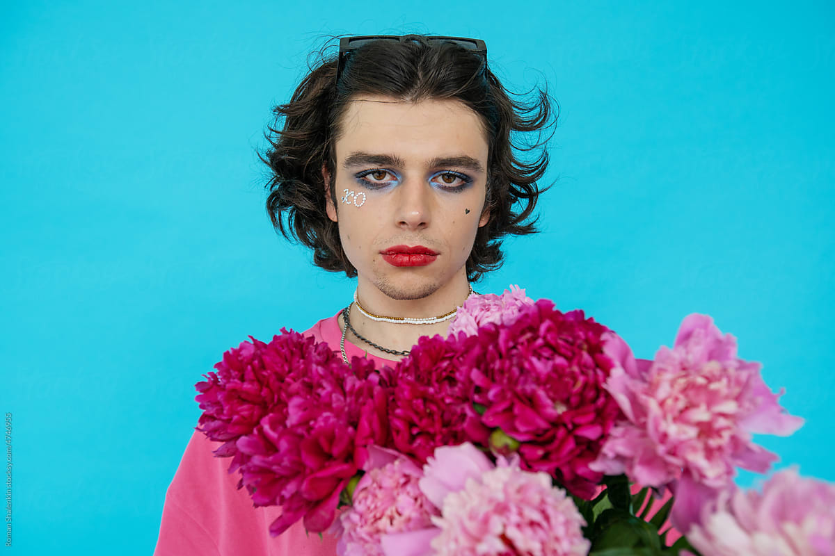 Non-Binary Man With Makeup Red Lips On and Flowers