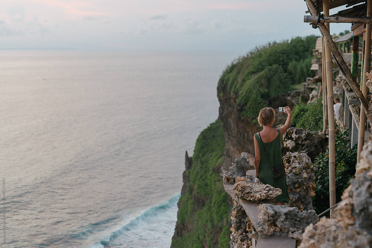 Woman Taking Selfie On A Edge Of Cliff Mountain