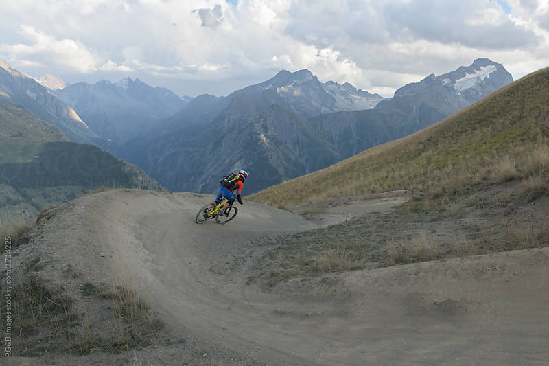 Man mountain biking downhill backcountry route in the Alps