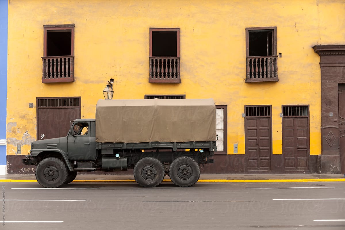 Modern army truck in front of spanish colonial facade
