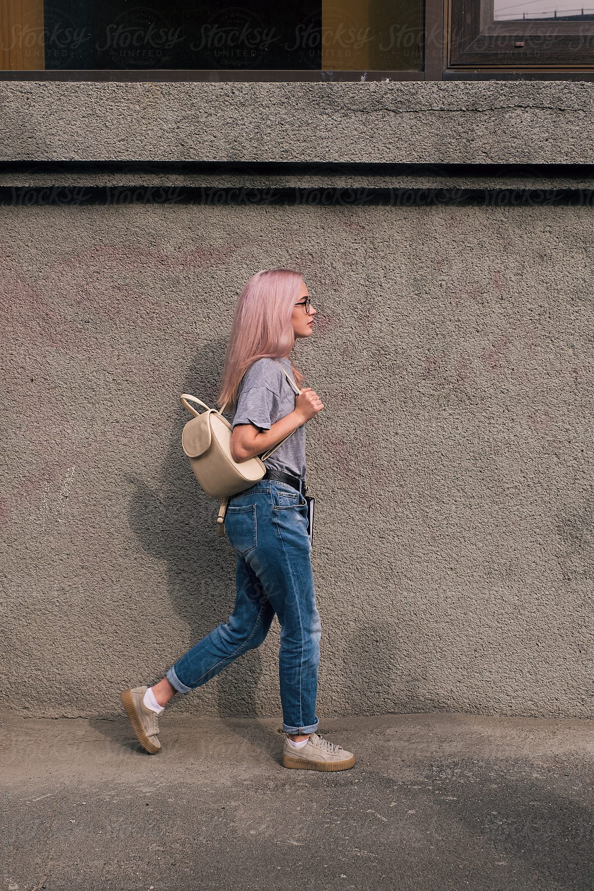 Walking Pink Haired Woman In Glasses With Rucksack By Stocksy