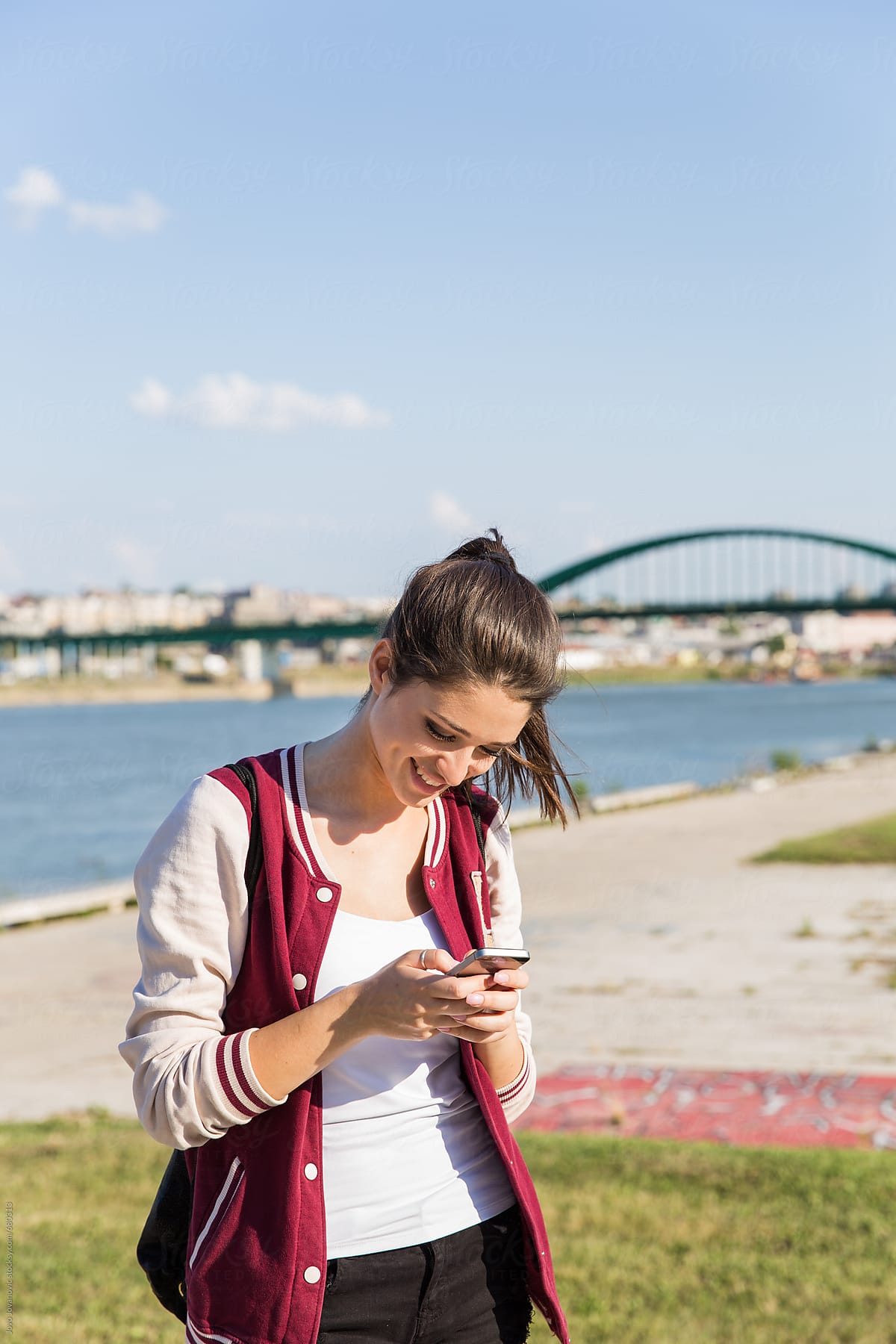 A Portrait Of A Smiling Beautiful Woman Texting With Her Phone By Stocksy Contributor Jovo