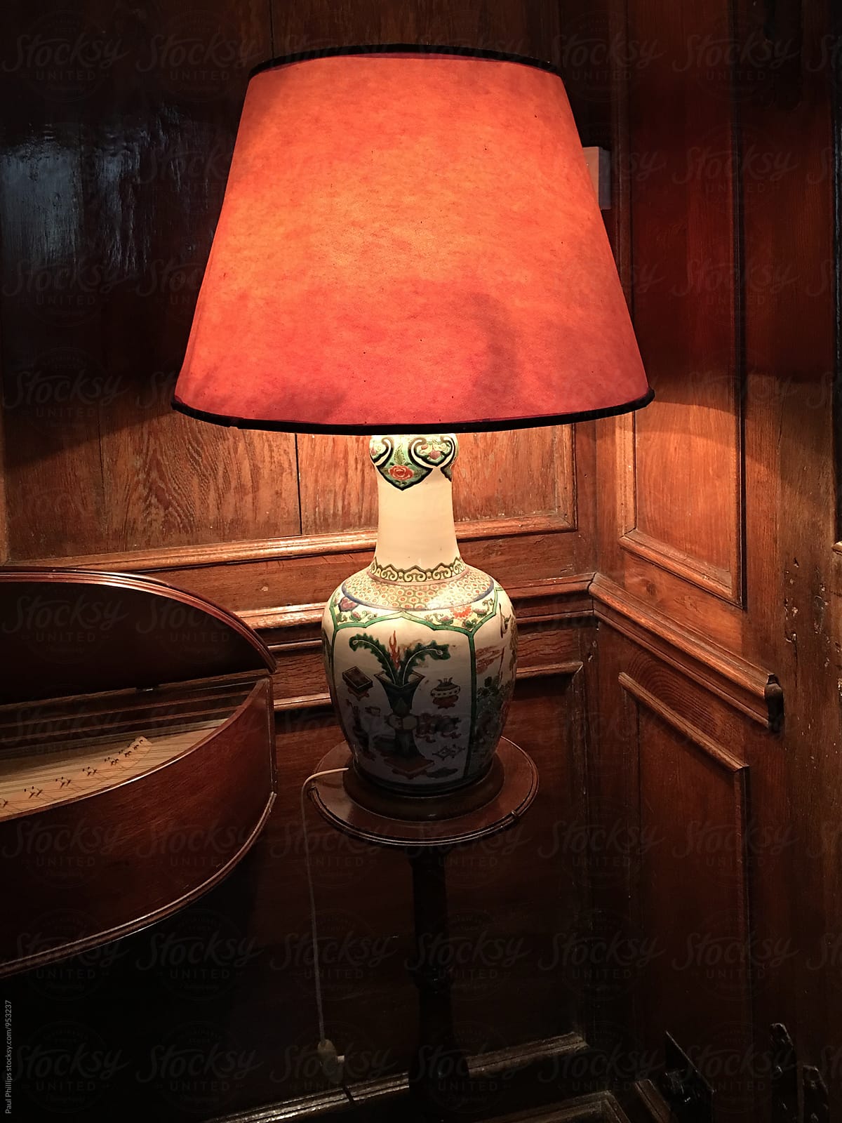Table lamp standing in the corner of a period room.