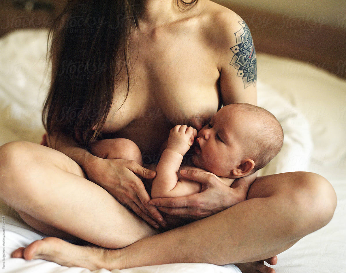Naked mother holding her child