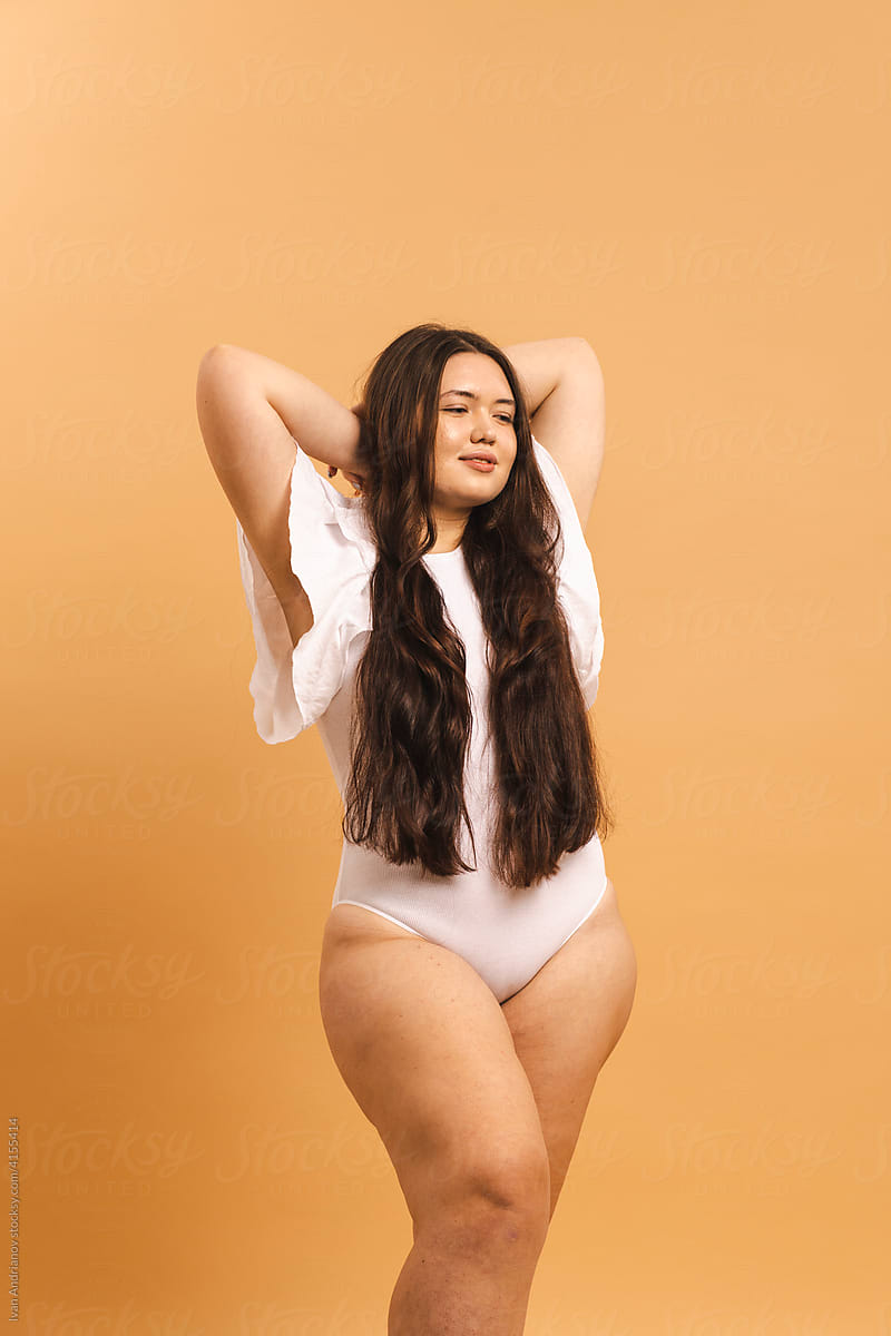 Beautiful plus size young woman in a studio