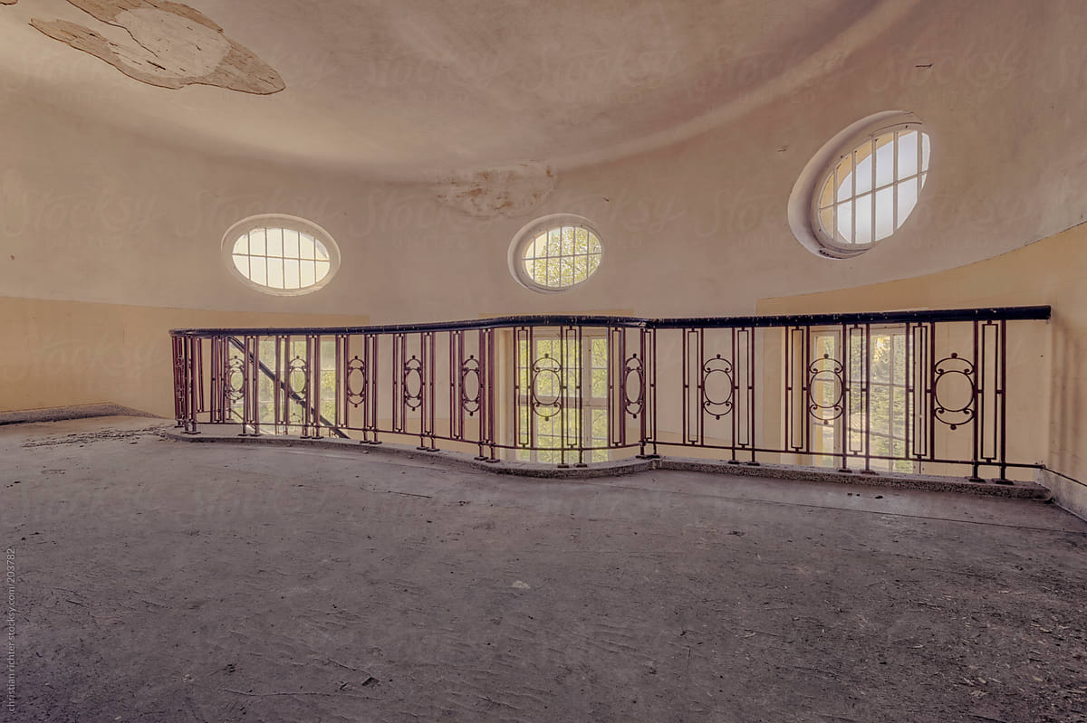 abandoned  staircase with round windows