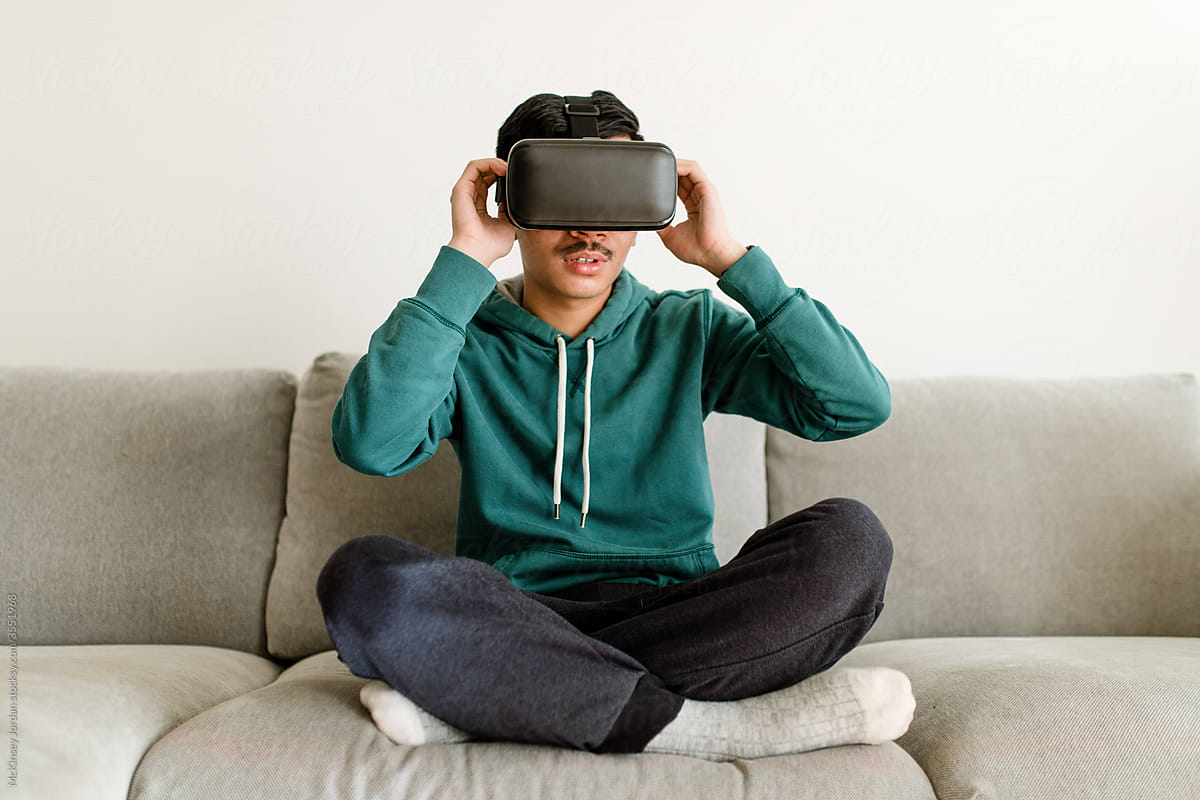 Man Adjusts Straps on VR Headset