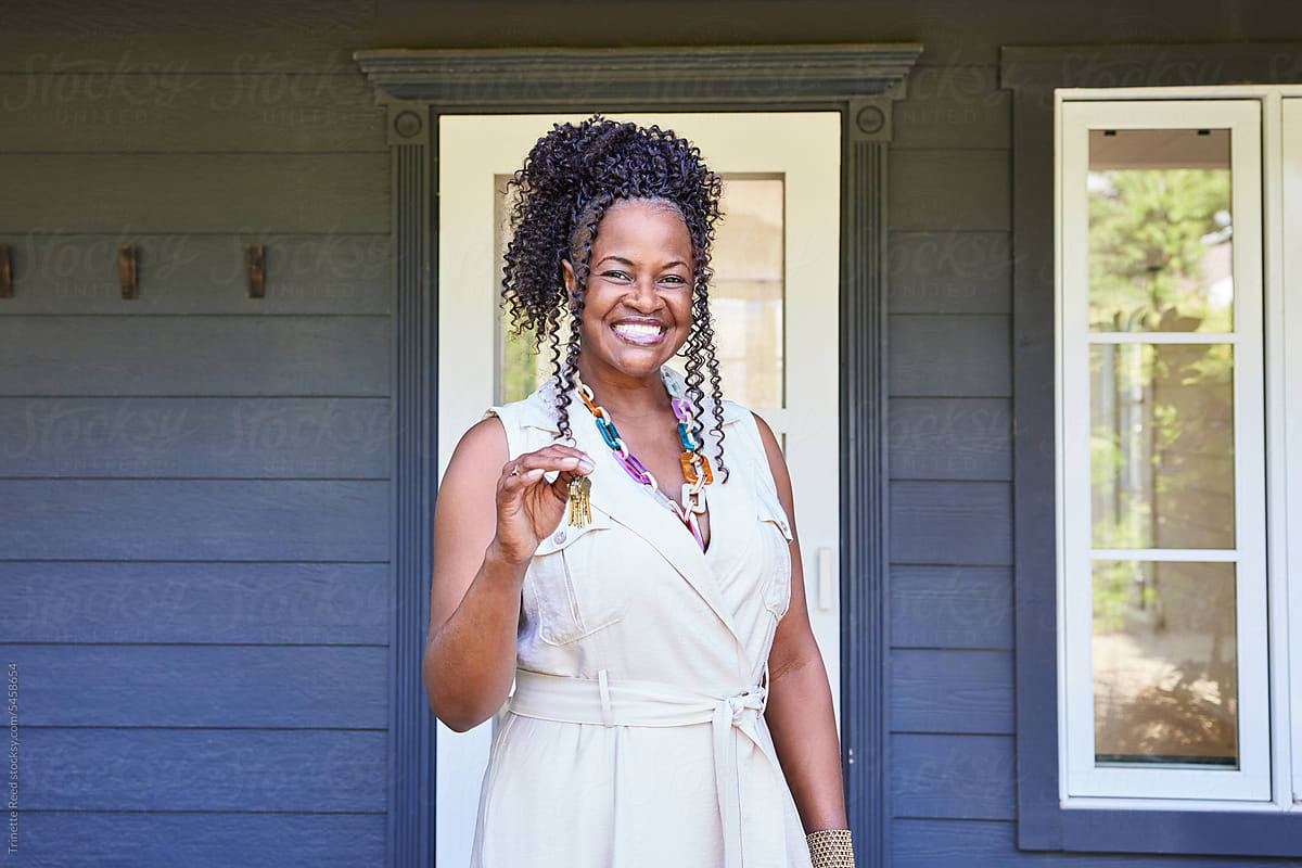 Portrait of excited mature Black woman new home owner holding keys