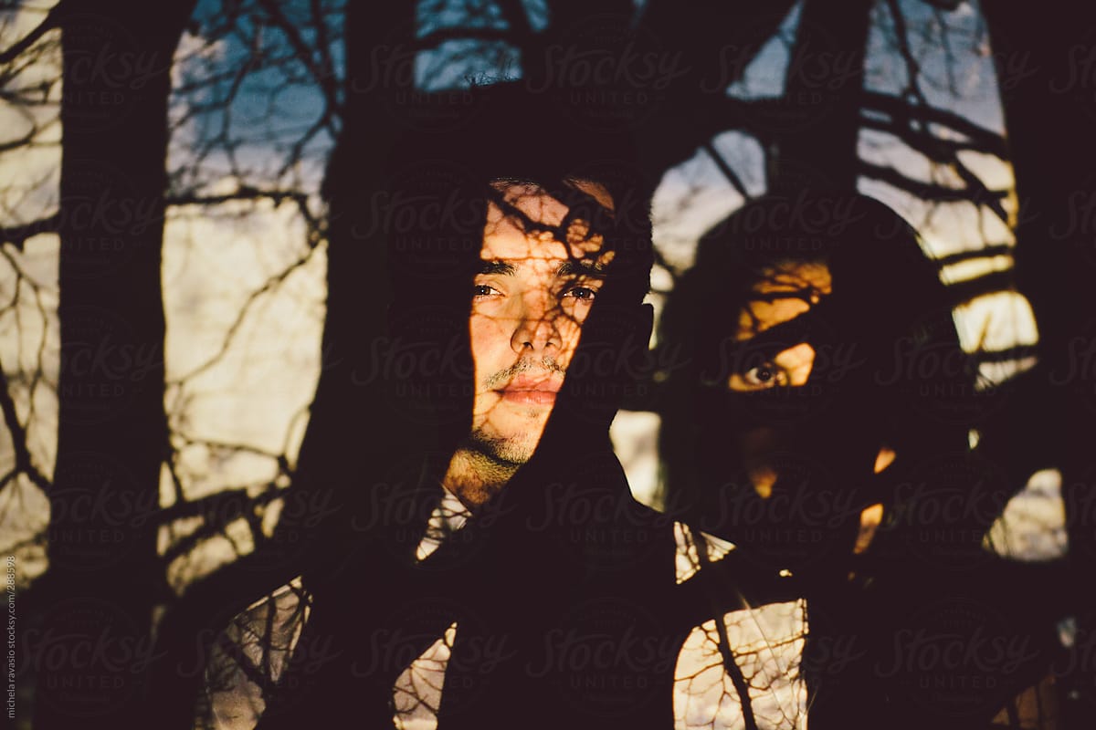 Young couple in the shadows of the branches