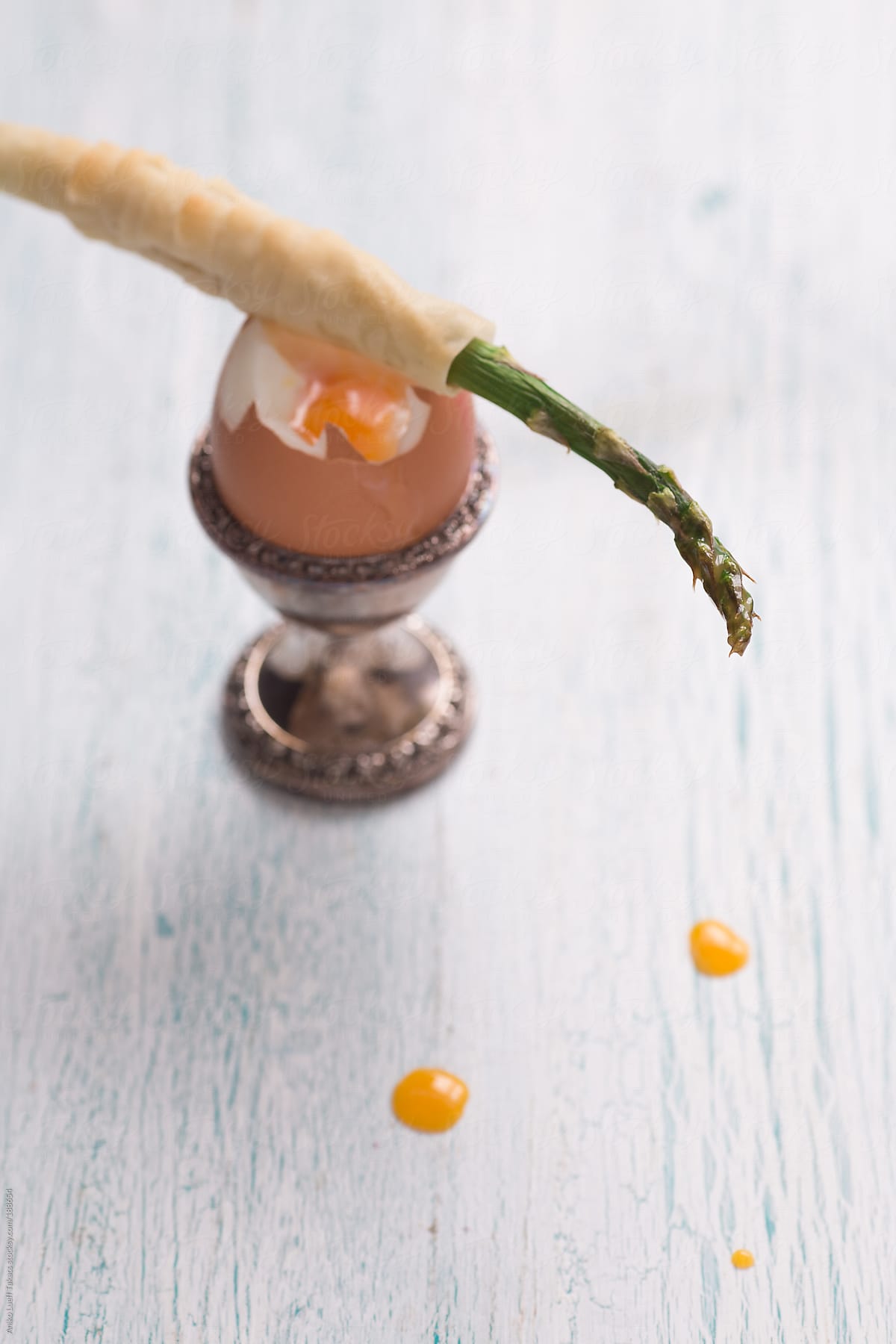 Green asparagus cigar and a soft boiled egg