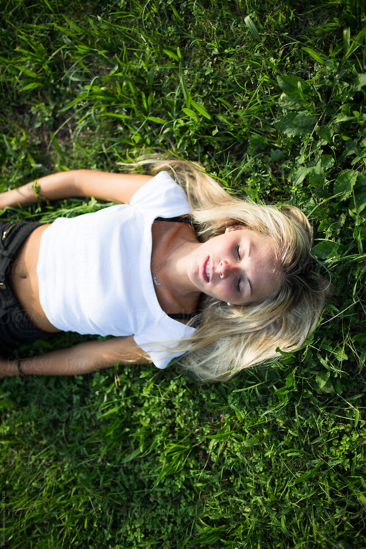 Girl Lying On The Grass By Stocksy Contributor Michela Ravasio