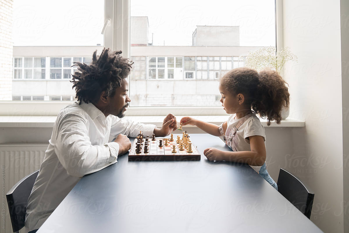 Father And Daughter Playing Chess