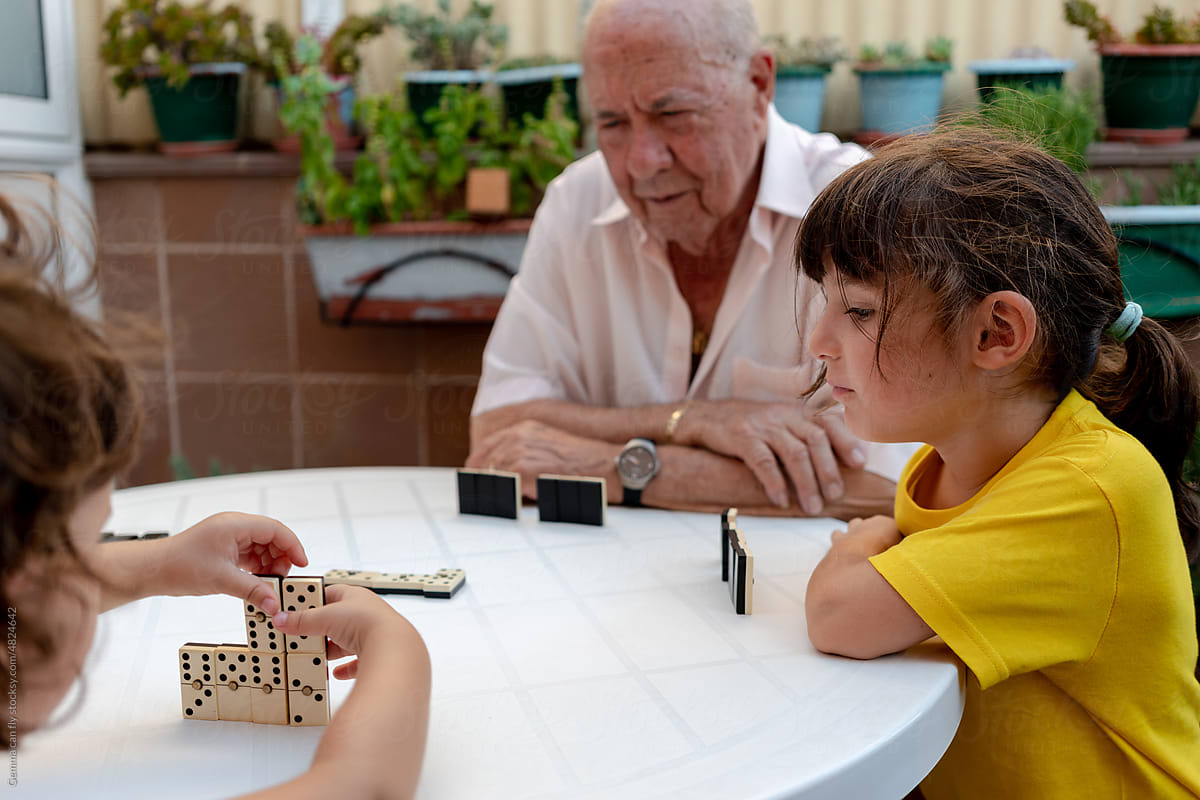 Family time playing domino with grandfather