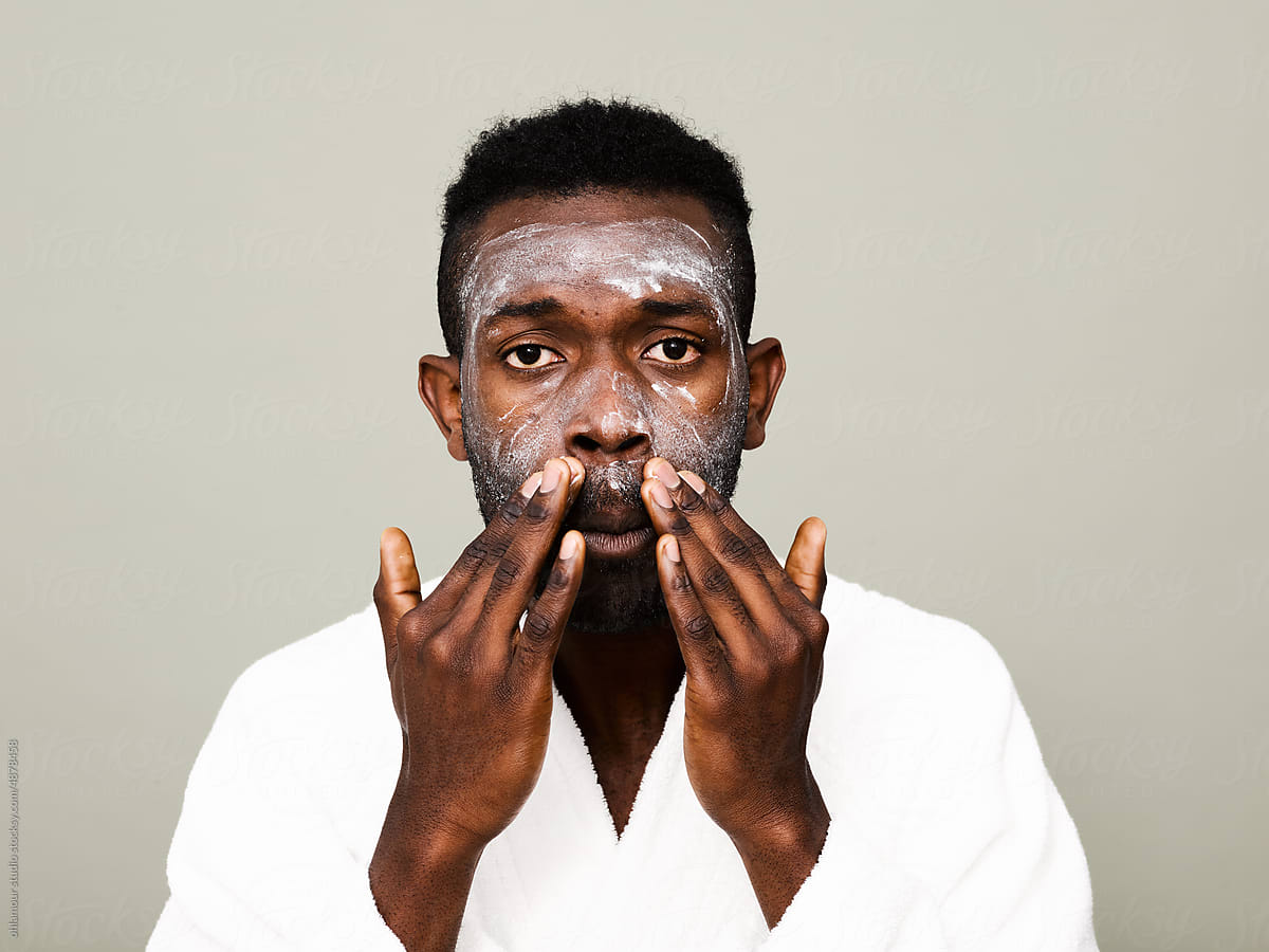Man applying facial beauty treatment