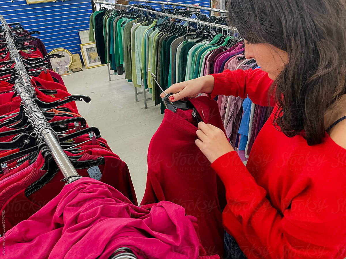 woman looking at clothes  thrift store
