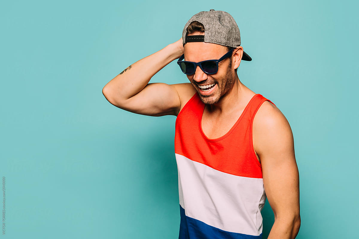 Happy handsome man with summer outfit over blue background