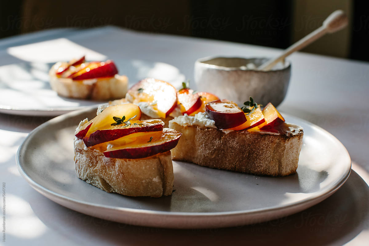Bruschetta topped with cream cheese, plums and honey.