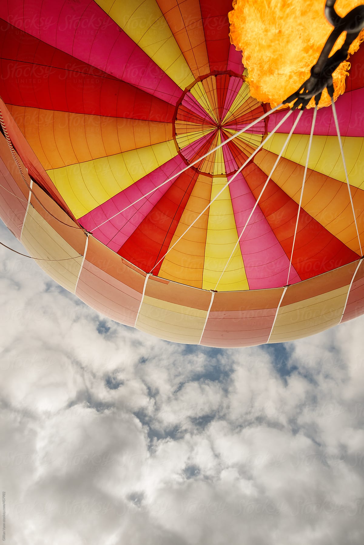 looking up into a hot air balloon canopy with a flame burst