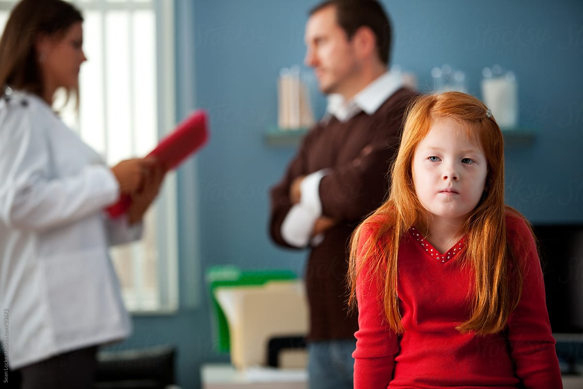 Exam Room: Girl Waits While Parent Discusses with Doctor