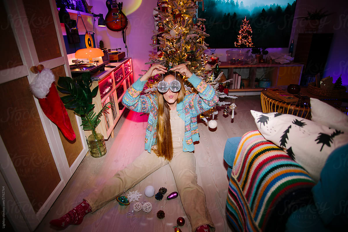 Woman plays around with ornaments for the Christmas tree