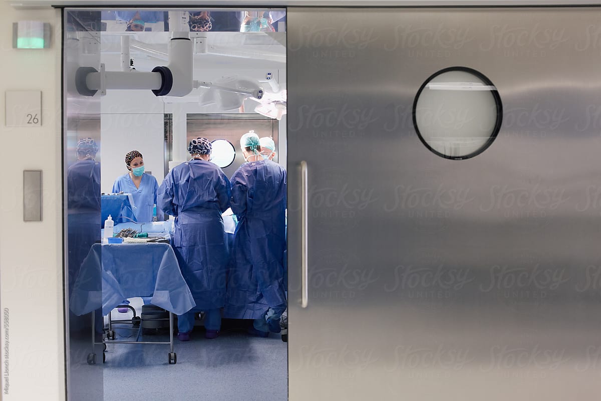 View through the door of operating room with healthcare workers inside