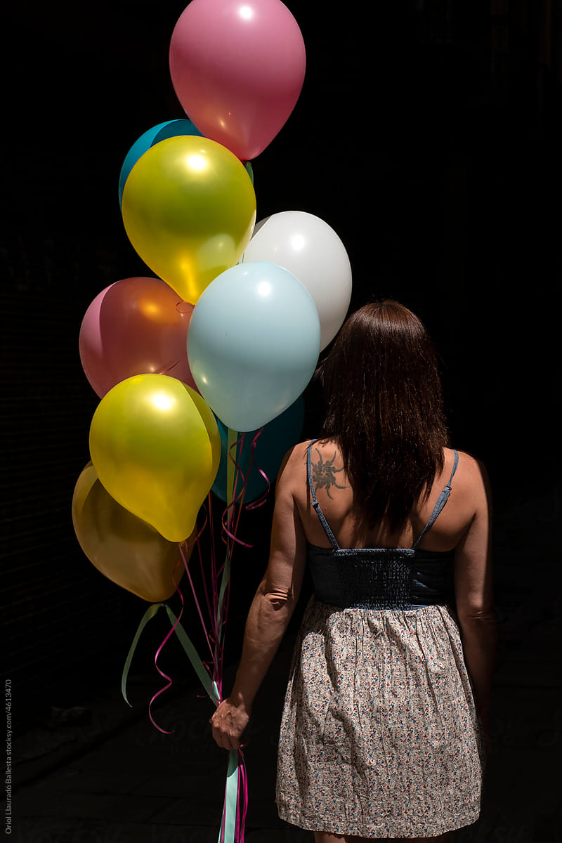 The beautiful woman with colored balloons