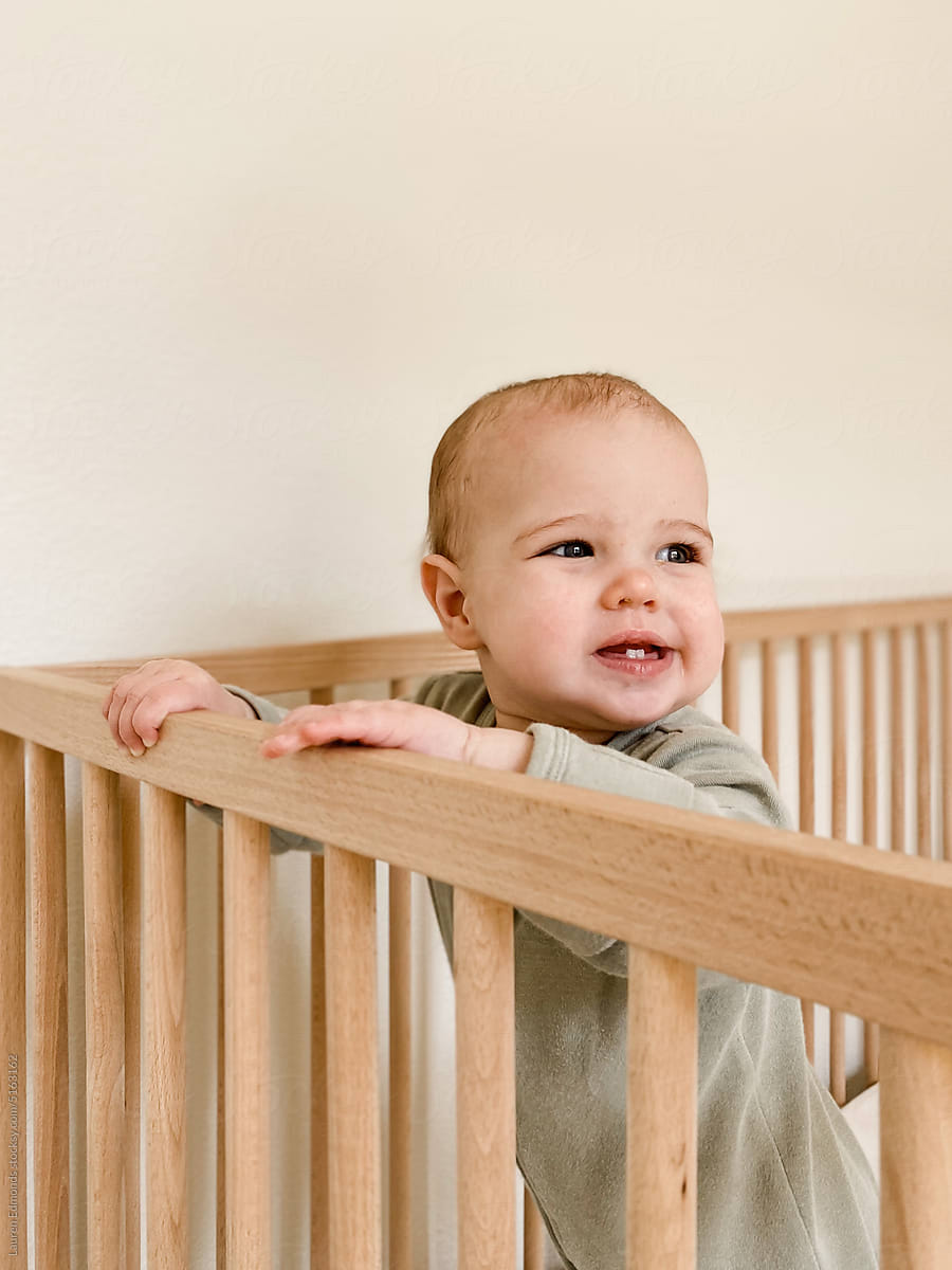 Baby girl smiling in crib
