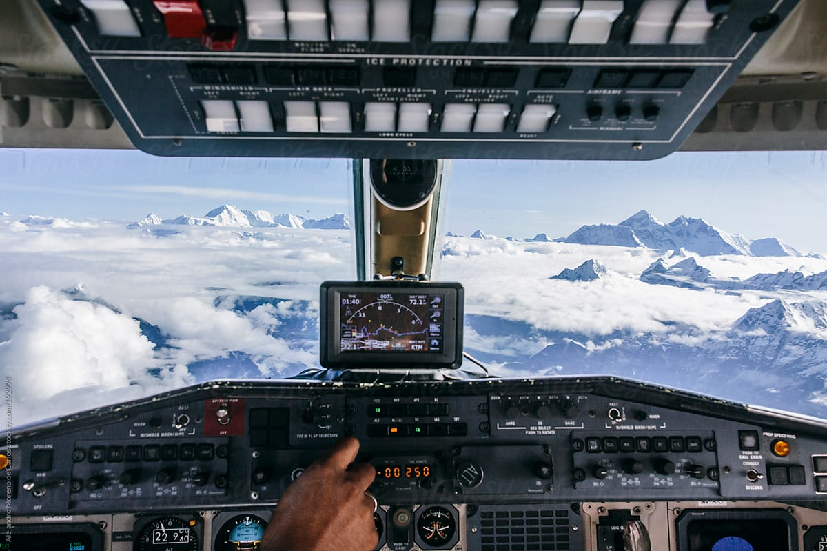 Airplane control cabin on a flight over Himalaya mountain range with Mount Everest on the background