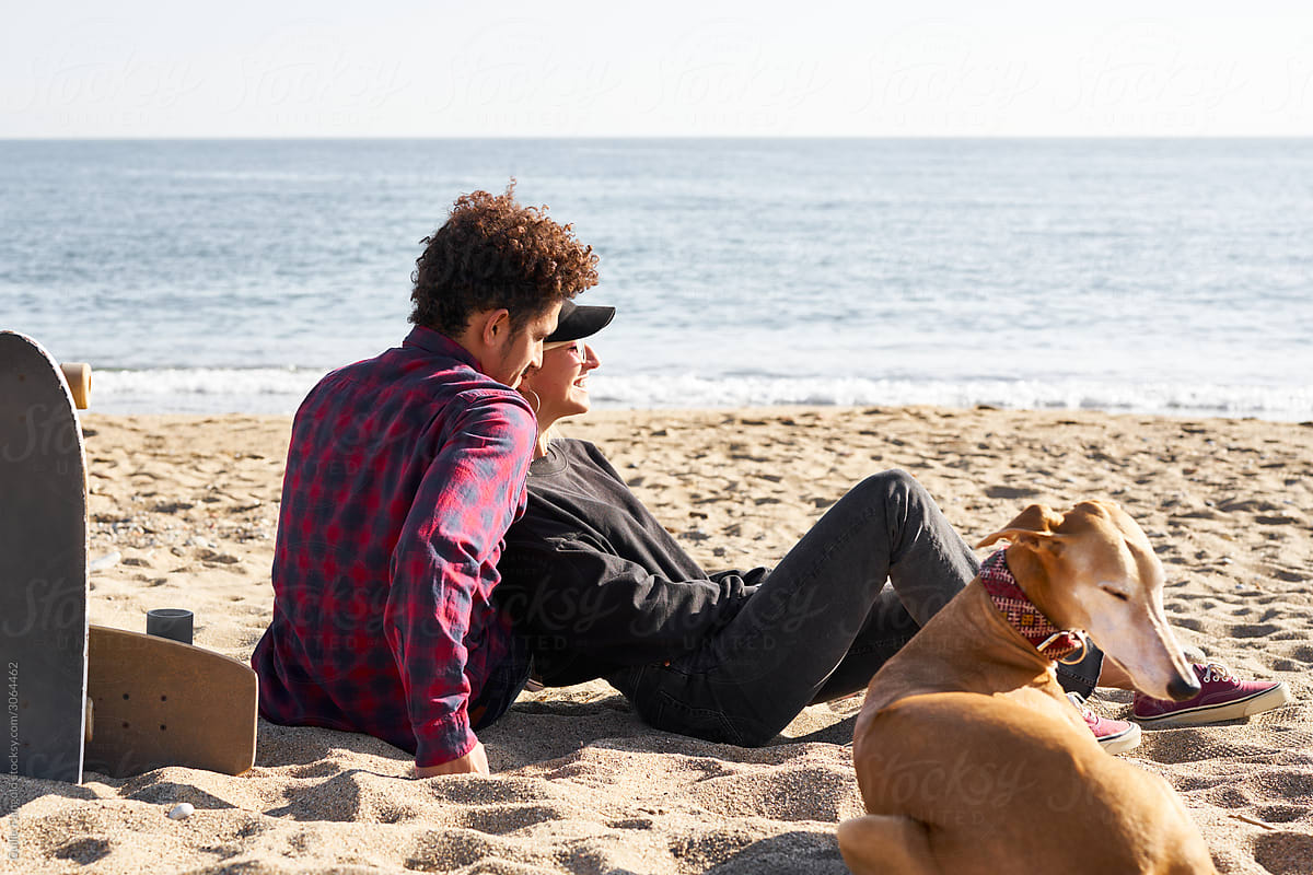 Romantic couple with dog on beach