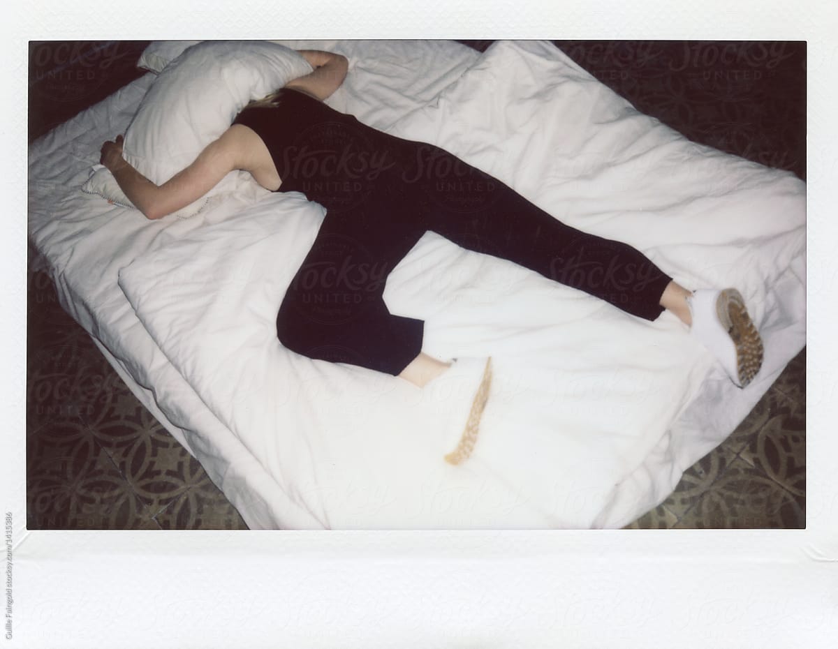 Woman In Jumpsuit Lying On Bed Under Pillow By Stocksy Contributor Guille Faingold Stocksy 1043