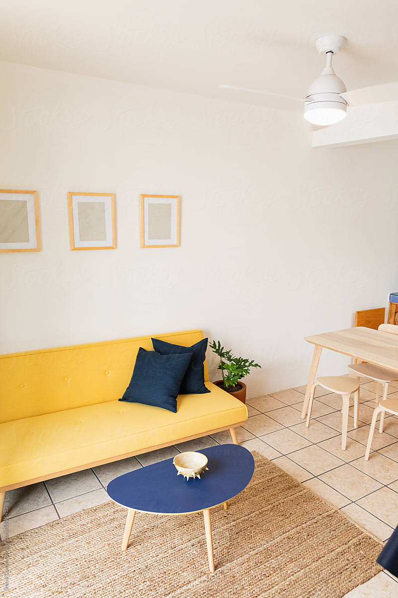 Yellow couch in a living room with copyspace