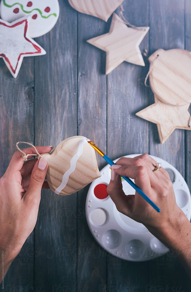 Christmas: Woman Painting Wooden Christmas Ornaments