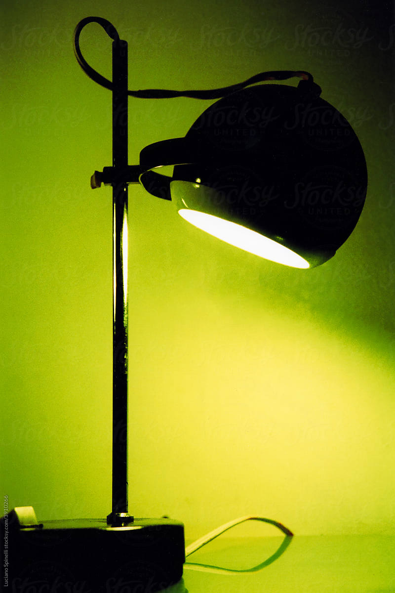 Close up photo of a metallic retro lamp with green light
