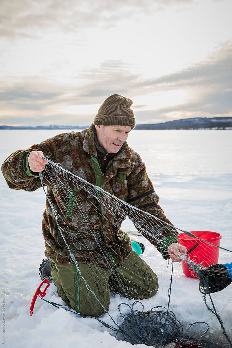 Senior ice fishing with nets